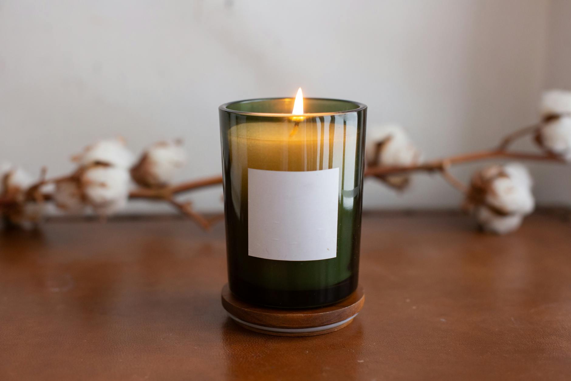 a burning candle with blank label
